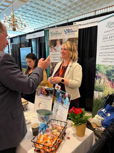 CALA Conference attendee visiting an exhibitor booth.