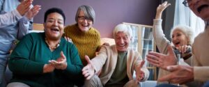 Assisted living residents playing a board game together.